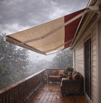 A second-floor deck with an awning, caught in a severe wind and rain storm.