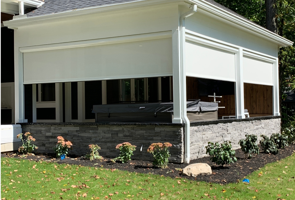 An enclosed space bordered by retractable screens for improved control over wind, shade, and privacy.